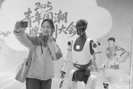 <br>          ■11月26日，北京，2025青年国潮品牌共创大会会场外，一位年轻人同一台人形智能机器人合影留念<br><br>        